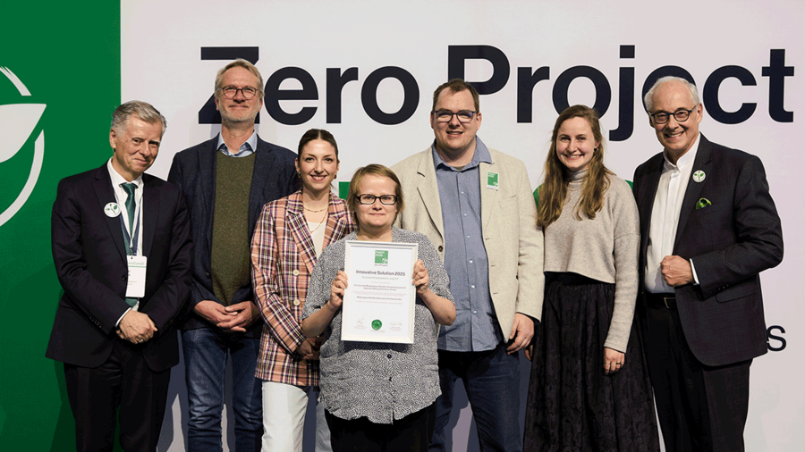 KIB members pose with a certificate for the Zero Project Award.